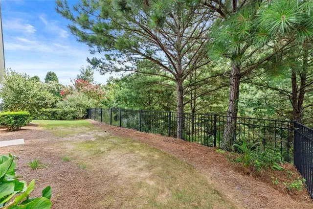 a view of a swimming pool and trees in the background