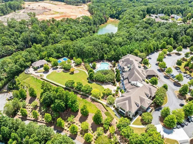 a backyard of a house with lots of green space and fountain