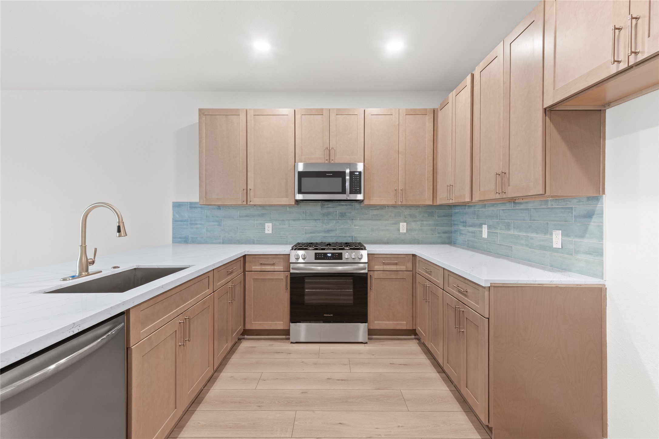 714 Northridge Terrace Lane Spring, TX 77373 - Photo 7 of 42 Completely updated kitchen with new cabinetry, quartz countertops, modern appliances, and a lovely tile backsplash!