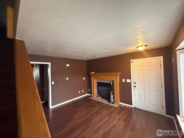 wooden floor in an empty room with a fireplace