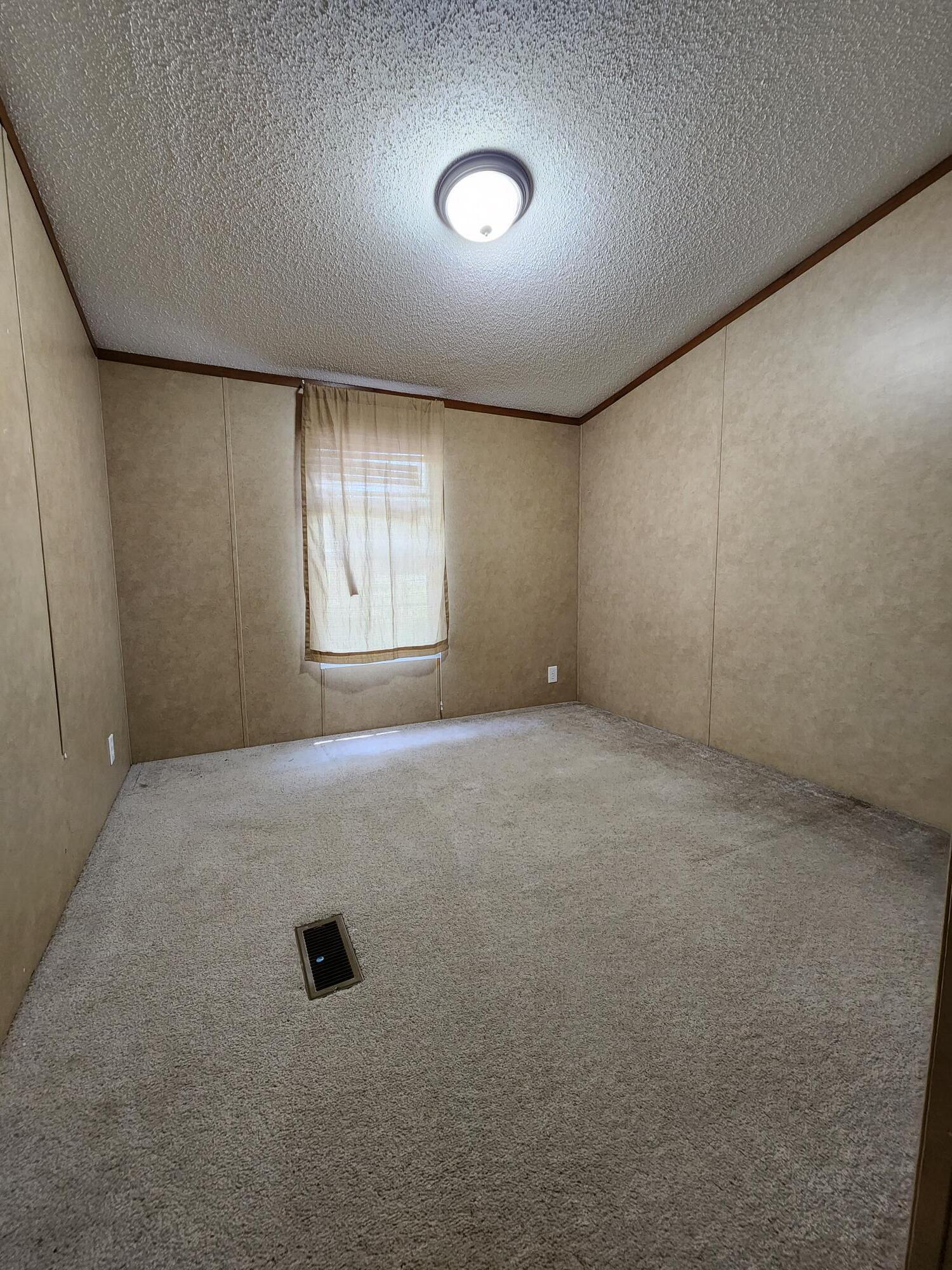5399 Fox Hound Lane Baker, FL 32531 - Photo 14 of 15 an empty room with windows & cabinet area