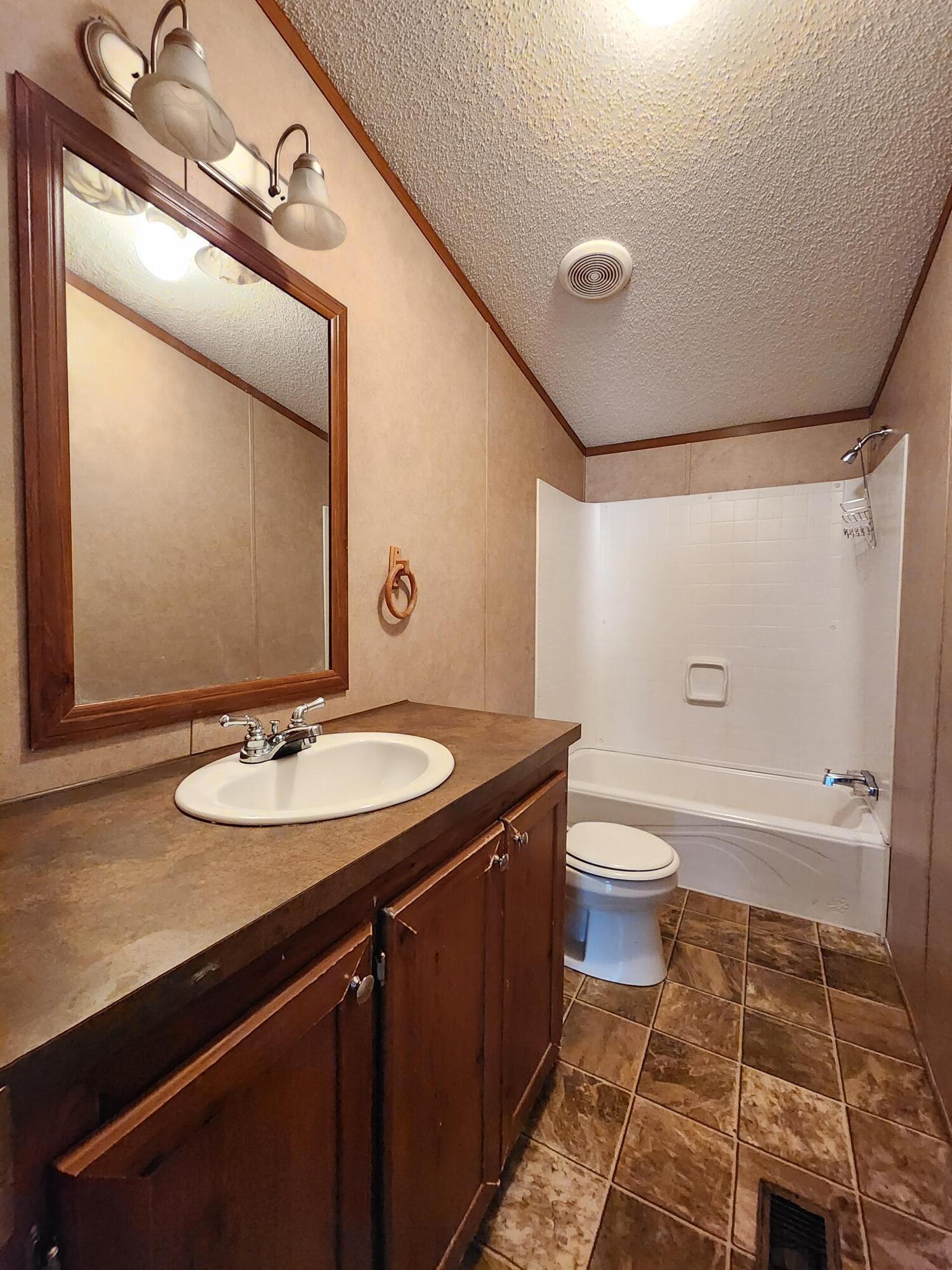 5399 Fox Hound Lane Baker, FL 32531 - Photo 15 of 15 a bathroom with a granite countertop sink toilet and shower