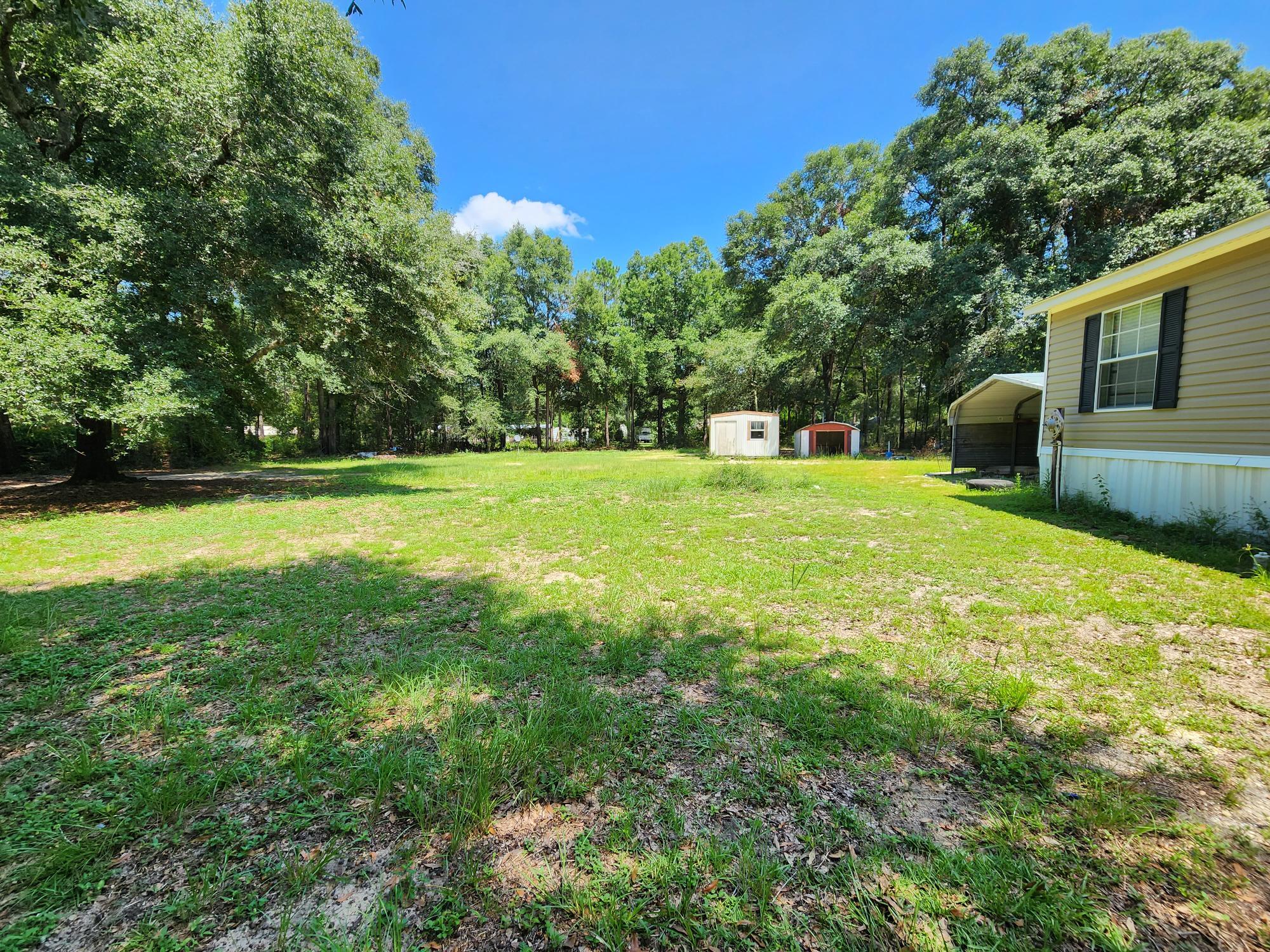 5399 Fox Hound Lane Baker, FL 32531 - Photo 2 of 15 a view of a backyard with a garden