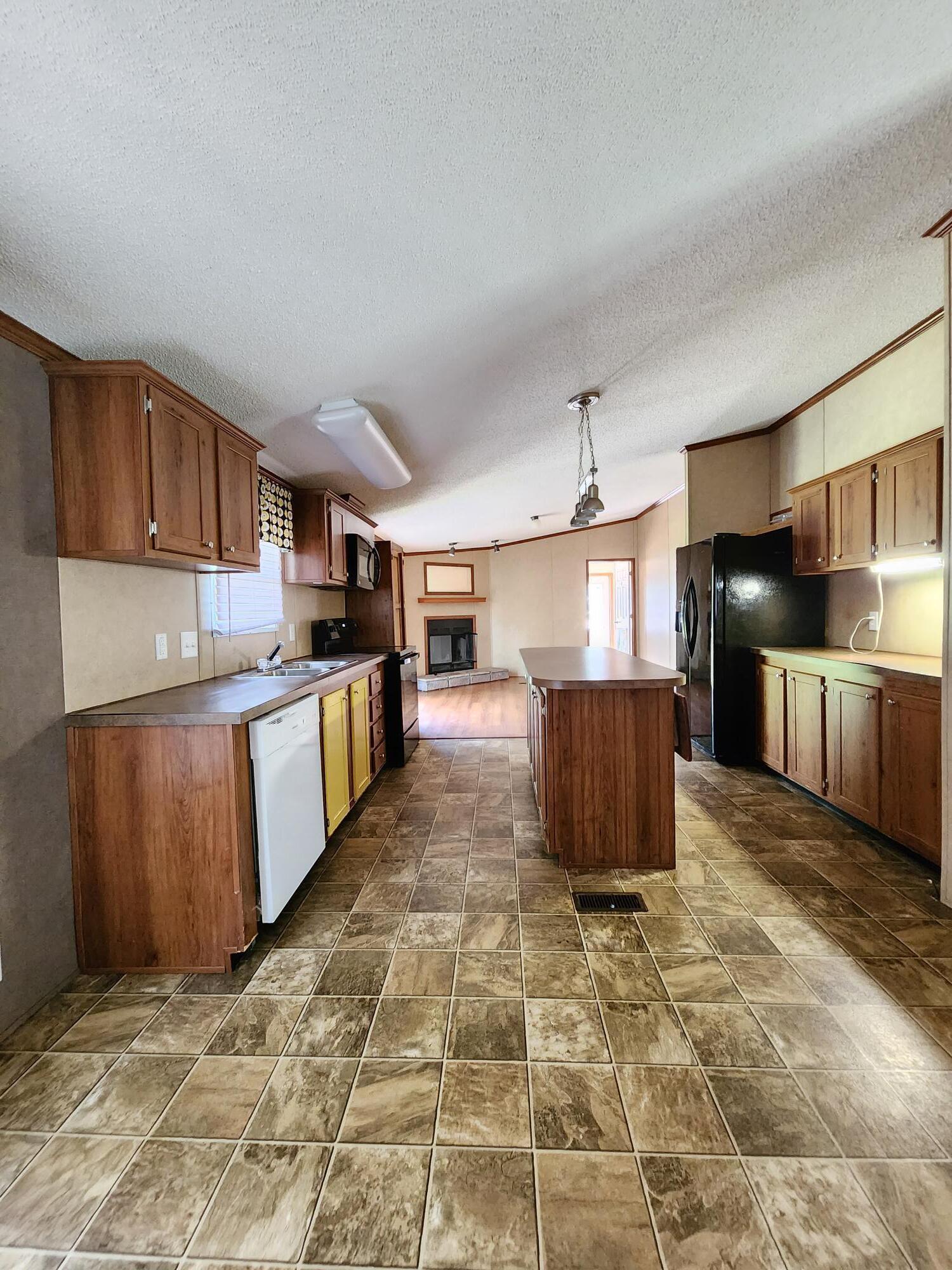 5399 Fox Hound Lane Baker, FL 32531 - Photo 6 of 15 a kitchen with stainless steel appliances granite countertop a stove a sink and a refrigerator