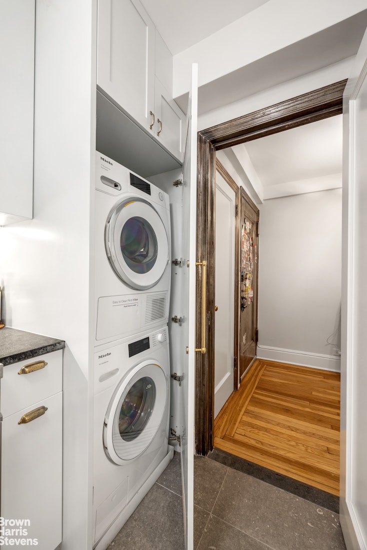 433 East 51st Street, Unit 2F Manhattan, NY 10022 - Photo 3 of 13 a utility room with dryer and washer