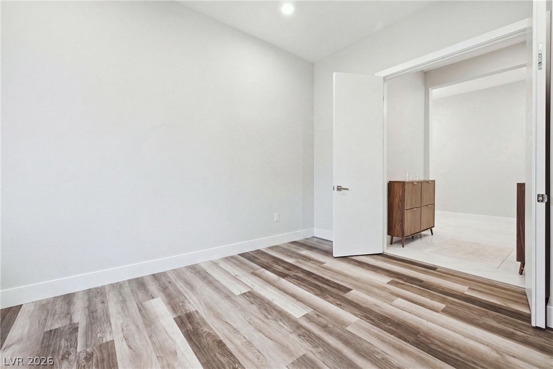 45 Garibaldi Way Henderson, NV 89011 - Photo 25 of 74 Flexible interior space with rich wood-toned flooring flows seamlessly into an adjoining room.