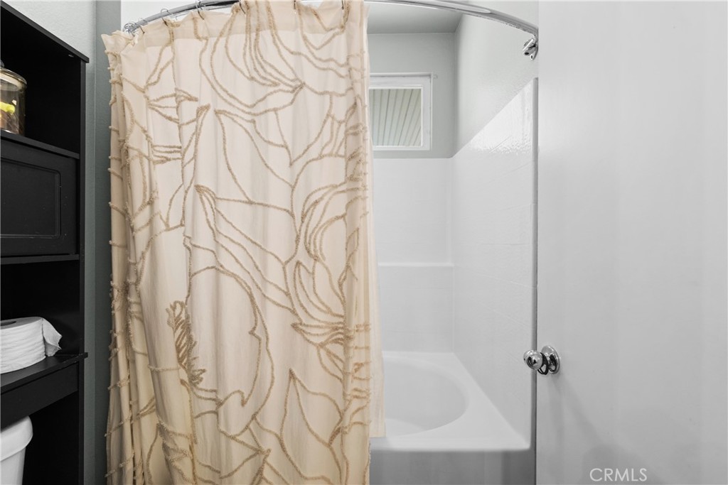 33411 Cam Piedra Rojo Temecula, CA 92592 - Photo 18 of 36 a bathroom with a shower curtain