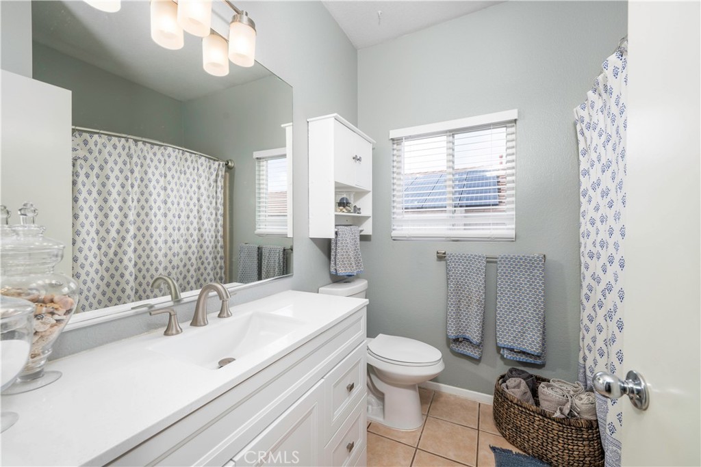 33411 Cam Piedra Rojo Temecula, CA 92592 - Photo 21 of 36 a bathroom with a sink a toilet a mirror and shower