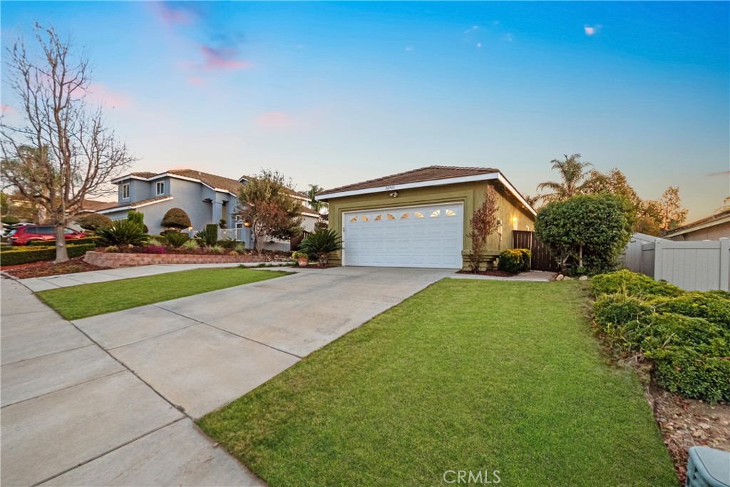 33411 Cam Piedra Rojo Temecula, CA 92592 - Photo 33 of 36 a front view of a house with a yard and garage