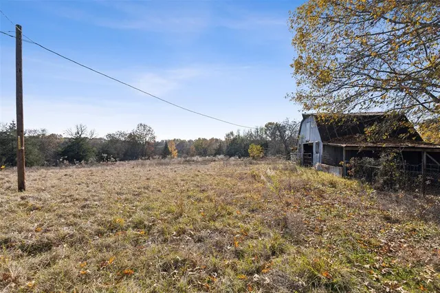 a front view of house with yard and trees around