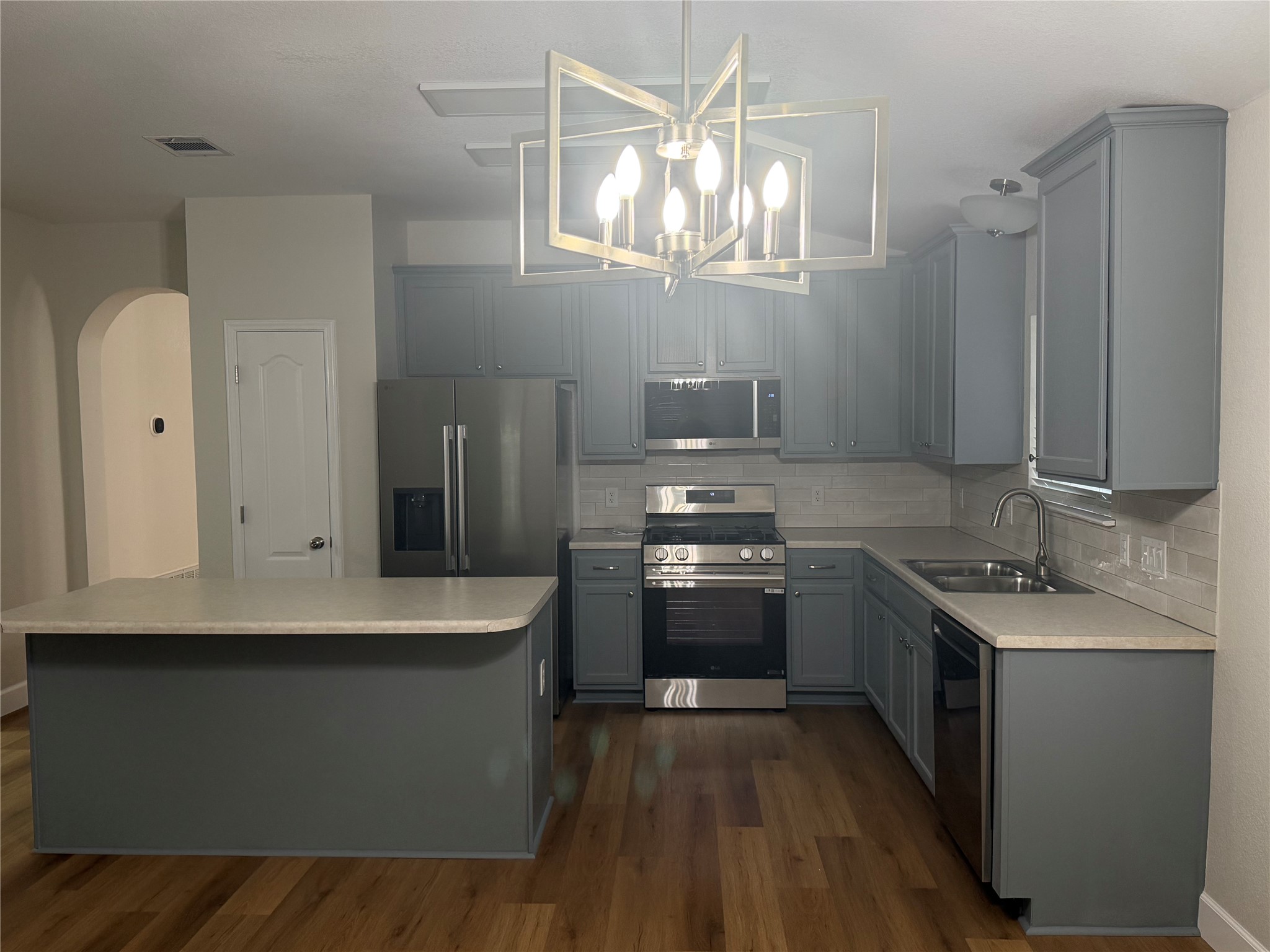 4604 Ramies Run Austin, TX 78749 - Photo 10 of 38 Warm wood flooring grounds this modern culinary space featuring an expansive center island.