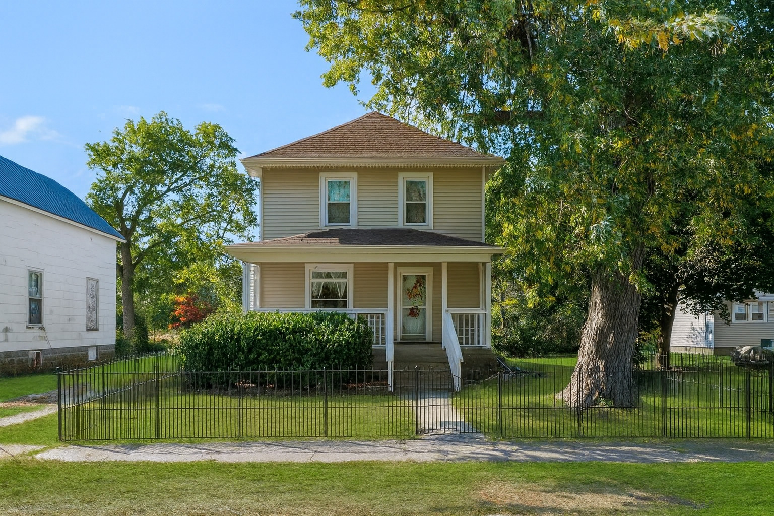a front view of a house with a garden