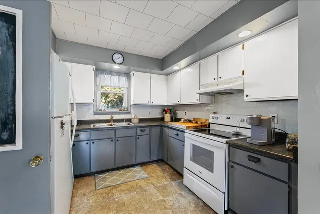 a kitchen with stainless steel appliances granite countertop a sink a stove and cabinets