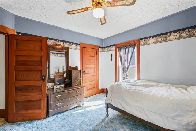 a bedroom with a bed and a dresser