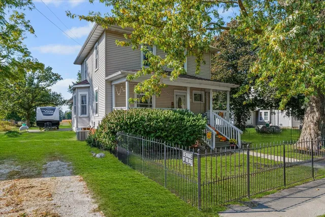 a front view of a house with a garden