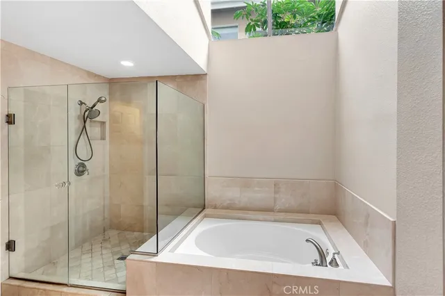 a spacious bathroom with a double vanity sink and a mirror