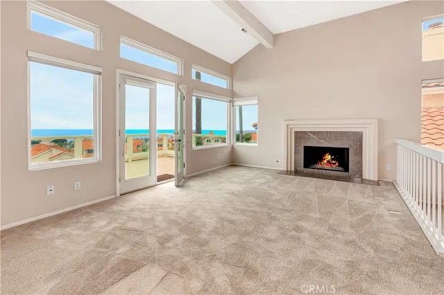 a view of an empty room with furniture and a fireplace