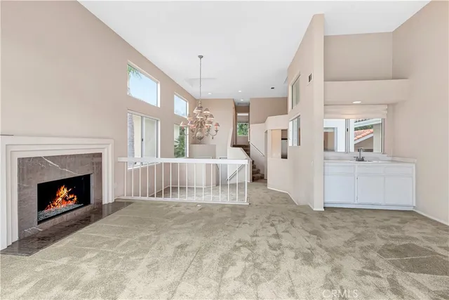 a view of a livingroom with an empty space and a fireplace