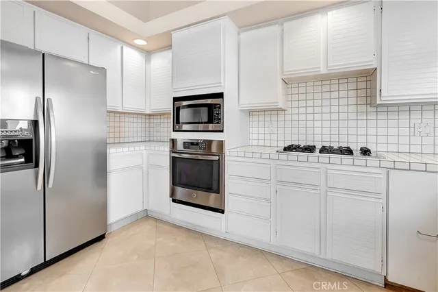 a view of a backyard with plants and palm tree