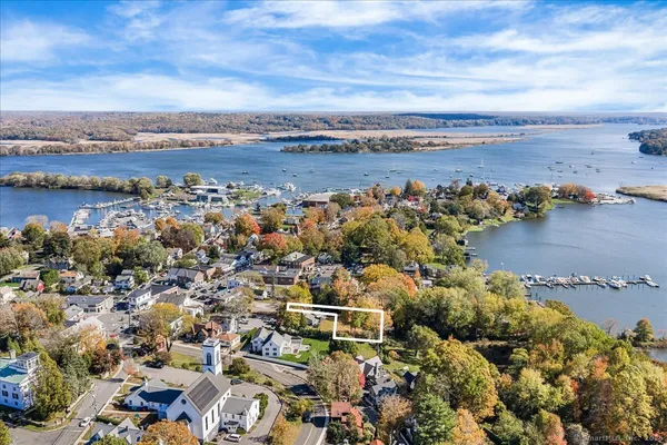an aerial view of residential houses with outdoor space and lake view
