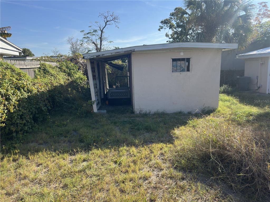 7211 James Street Port Richey, FL 34668 - Photo 14 of 14 a backyard of a house with a yard and garage
