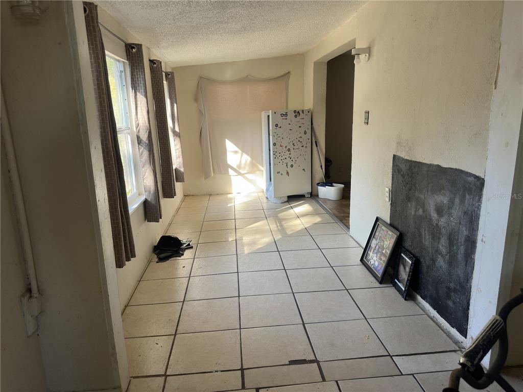 7211 James Street Port Richey, FL 34668 - Photo 2 of 14 a view of an empty room with wooden floor and a bathroom