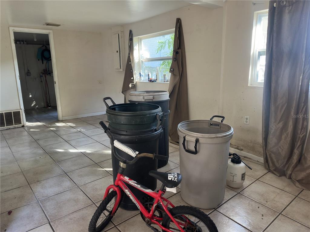 7211 James Street Port Richey, FL 34668 - Photo 3 of 14 a living room with a toilet and a window