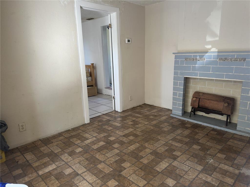 7211 James Street Port Richey, FL 34668 - Photo 6 of 14 a view of empty room with fireplace