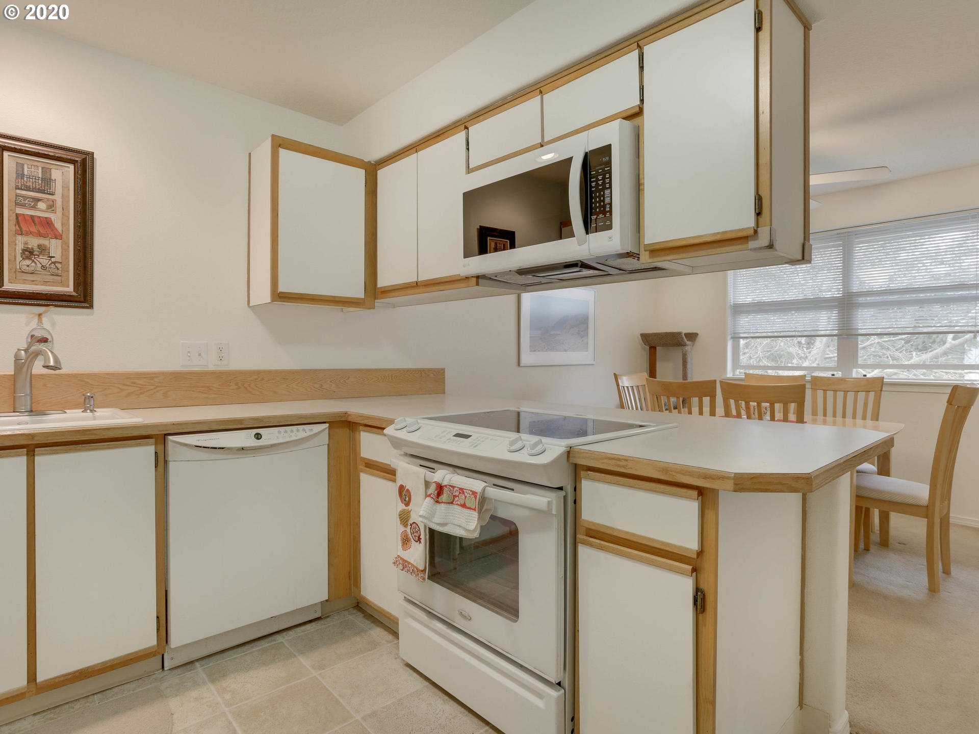 4614 West Powell Boulevard, Unit 261 Gresham, OR 97030 - Photo 14 of 29 a kitchen with stainless steel appliances granite countertop a stove microwave and cabinets