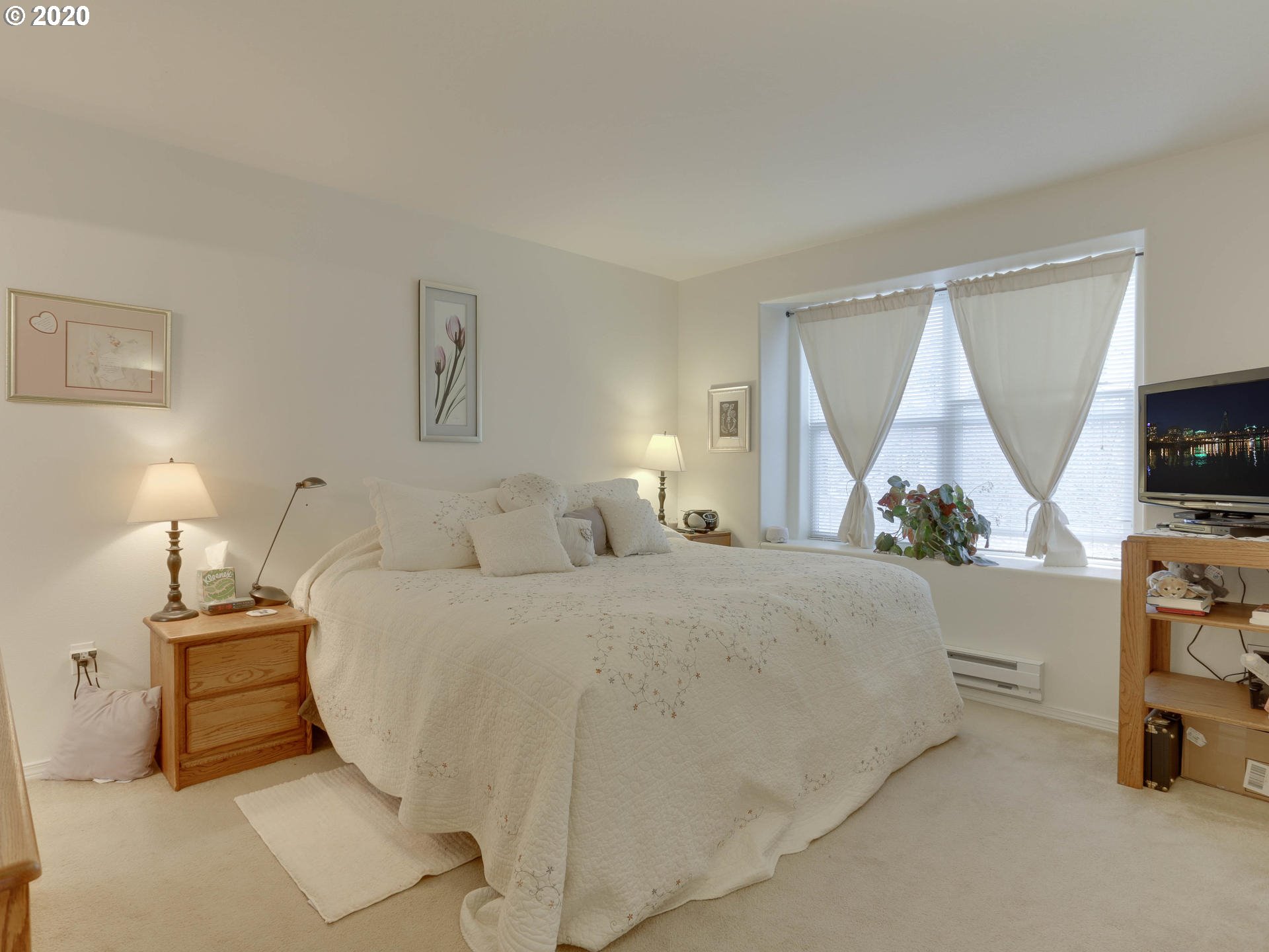 4614 West Powell Boulevard, Unit 261 Gresham, OR 97030 - Photo 18 of 29 a bedroom with a bed and a flat tv screen on the dresser
