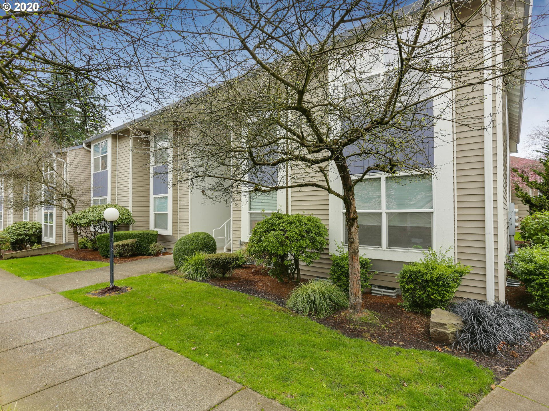 4614 West Powell Boulevard, Unit 261 Gresham, OR 97030 - Photo 2 of 29 a front view of a house with garden and plants