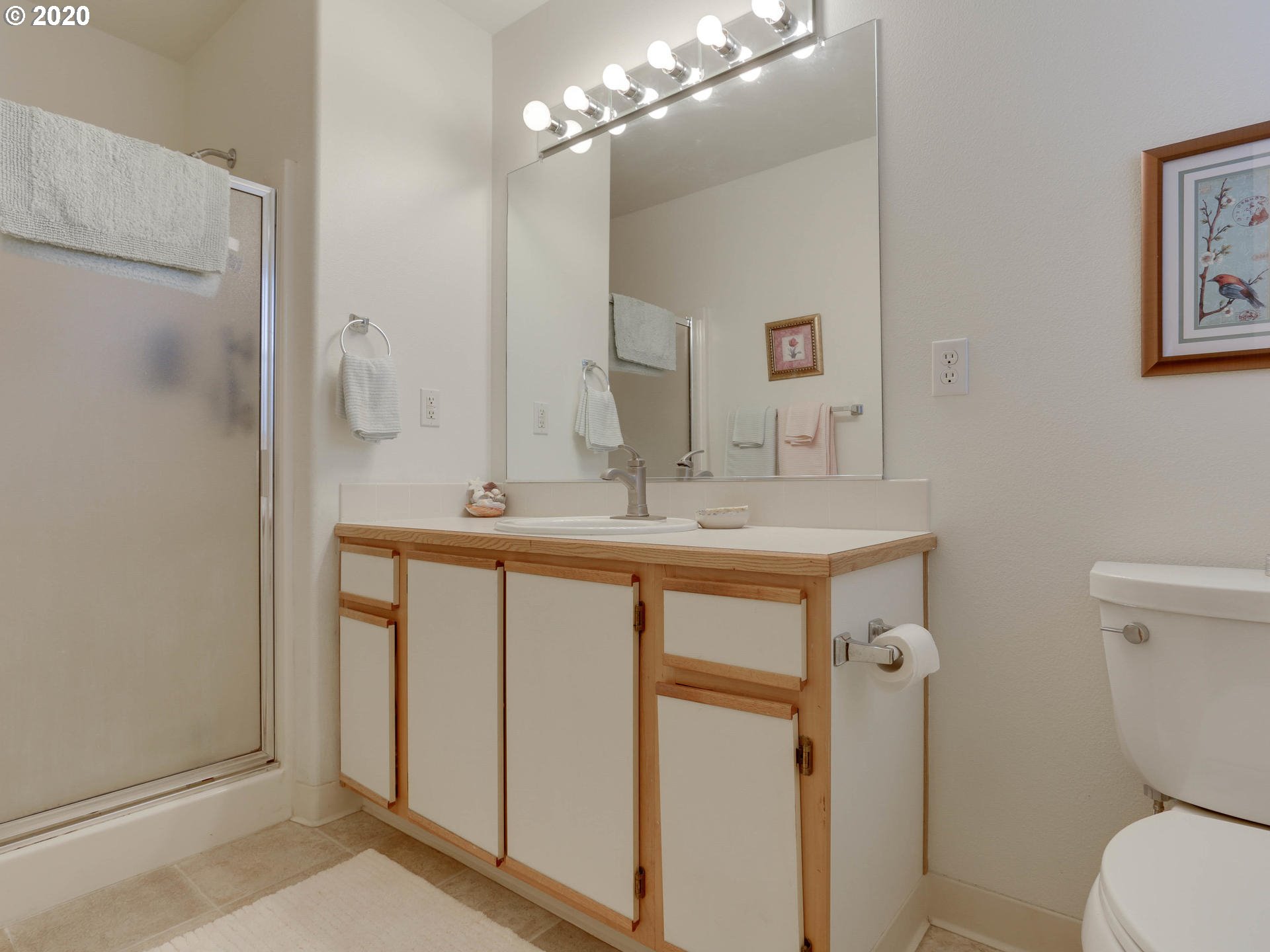 4614 West Powell Boulevard, Unit 261 Gresham, OR 97030 - Photo 21 of 29 a bathroom with a sink a toilet a large mirror and shower