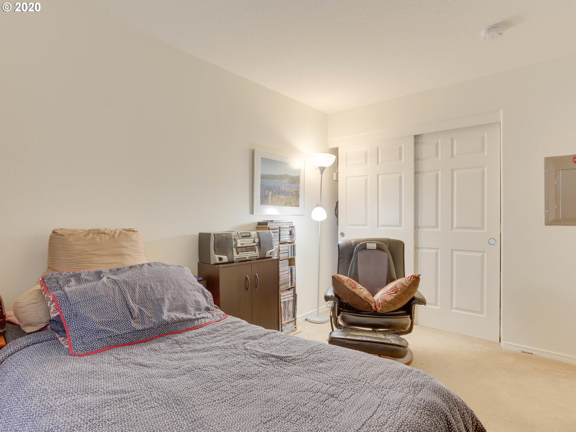 4614 West Powell Boulevard, Unit 261 Gresham, OR 97030 - Photo 24 of 29 a bedroom with a bed and wooden floor