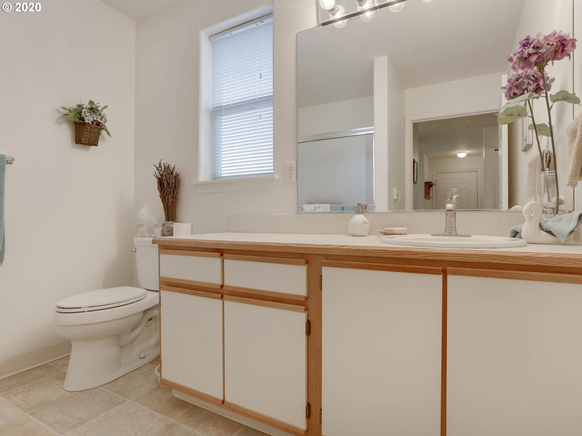 4614 West Powell Boulevard, Unit 261 Gresham, OR 97030 - Photo 26 of 29 a bathroom with a sink a toilet and mirror