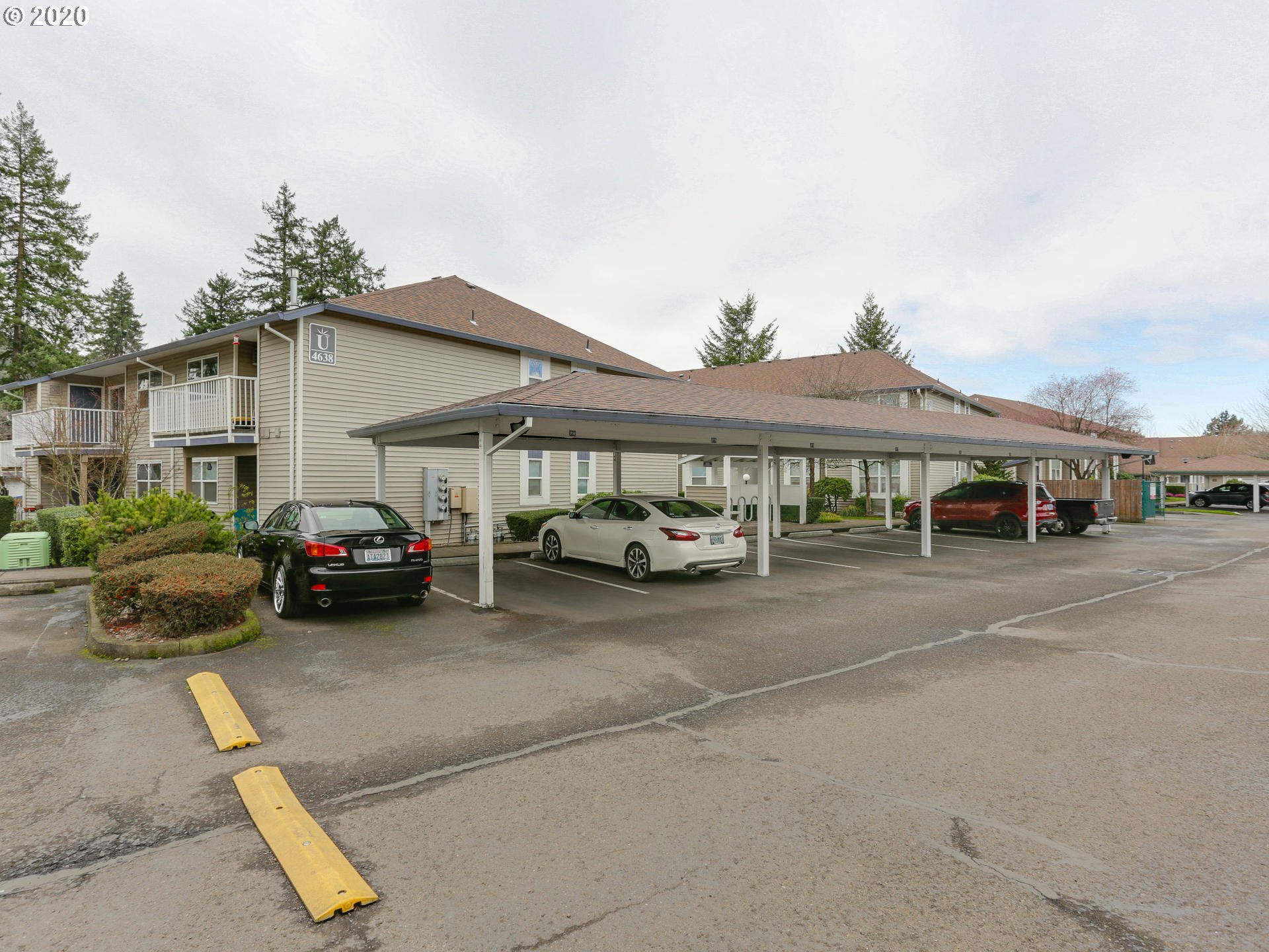 4614 West Powell Boulevard, Unit 261 Gresham, OR 97030 - Photo 27 of 29 a couple of cars parked in front of a house