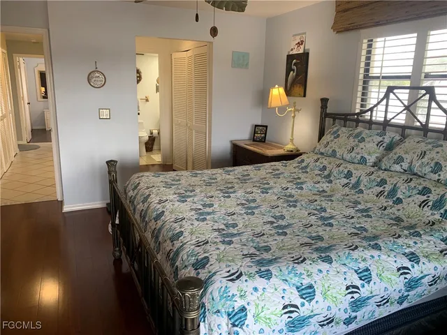 a bedroom with a bed dresser and a window