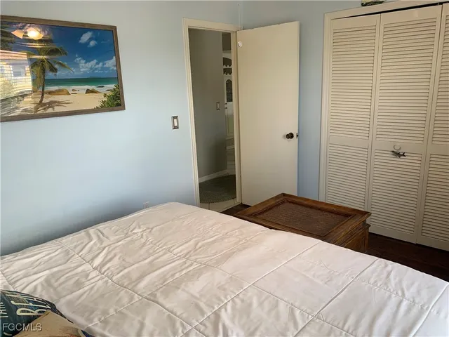 a bedroom with a bed and a mirror