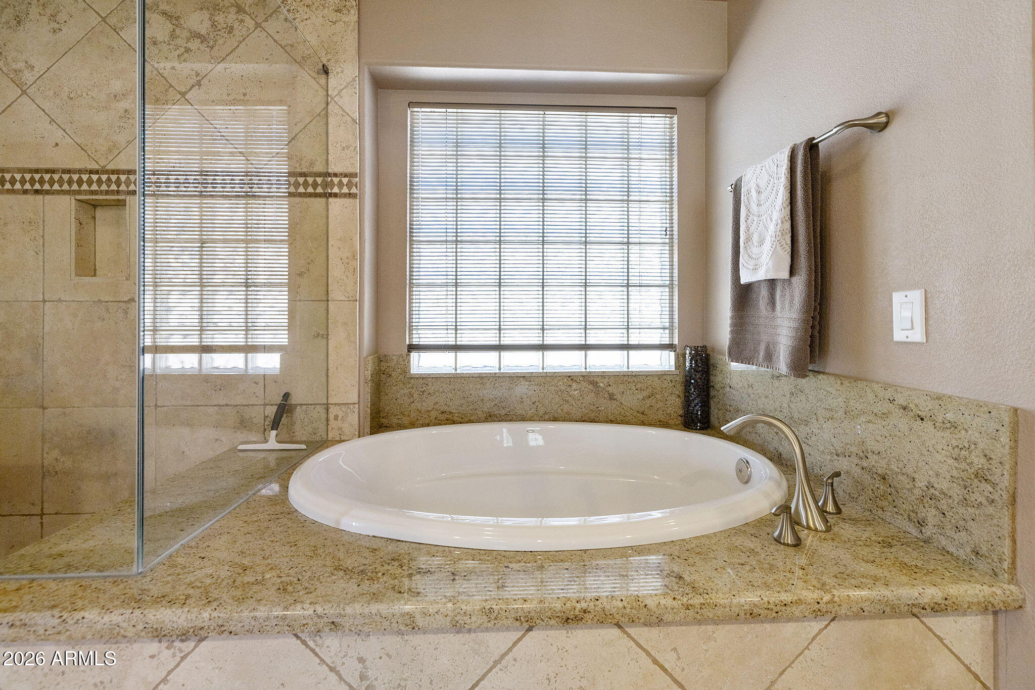 12435 West Monte Vista Road Avondale, AZ 85392 - Photo 44 of 69 a bath tub sitting in a bathroom next to a window