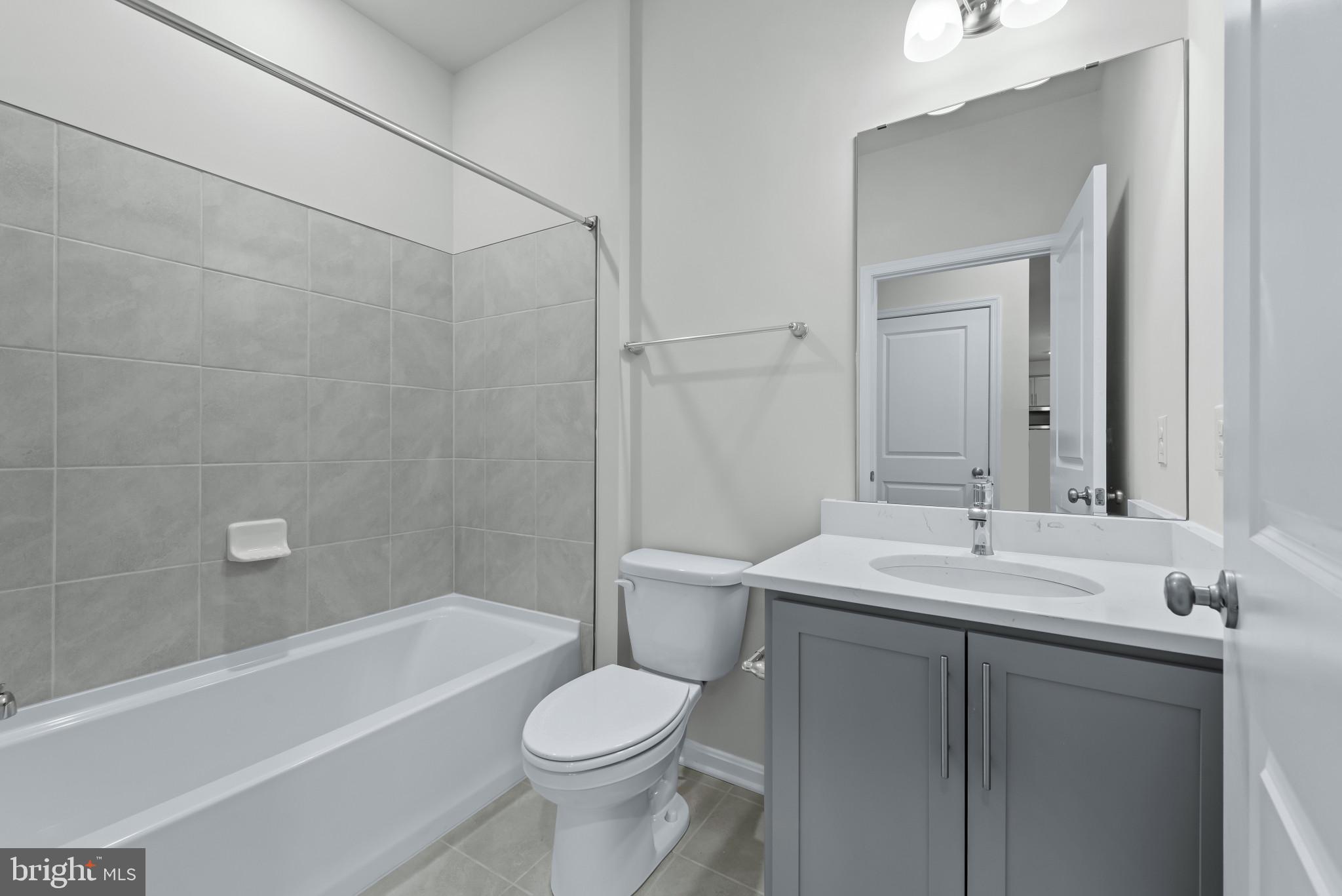 1204 Otter Point Middle River, MD 21220 - Photo 13 of 32 a bathroom with a sink a toilet and shower