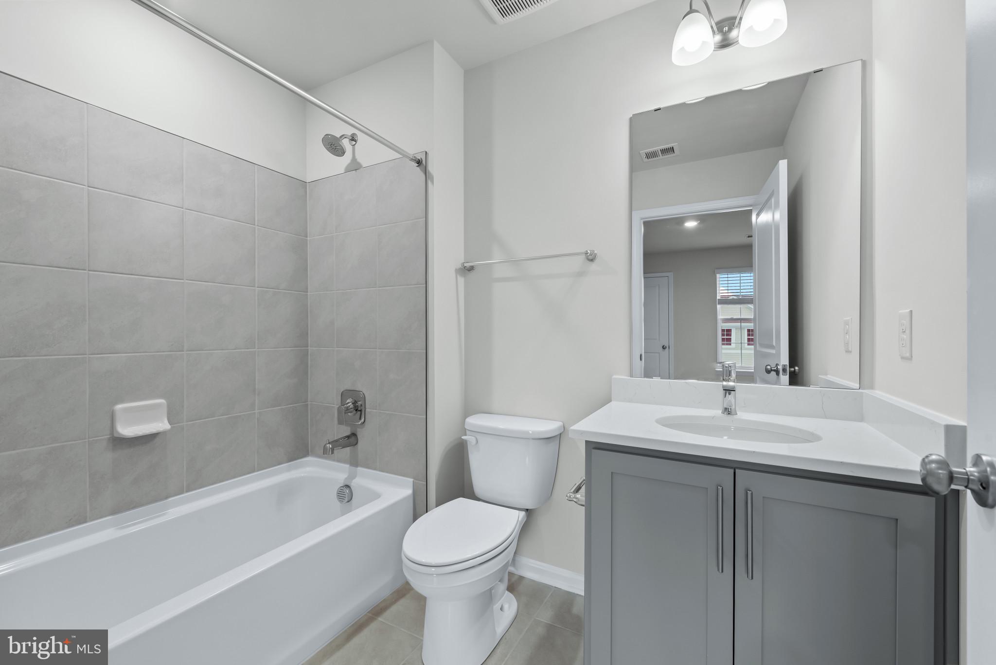 1204 Otter Point Middle River, MD 21220 - Photo 23 of 32 a bathroom with a sink toilet vanity and shower