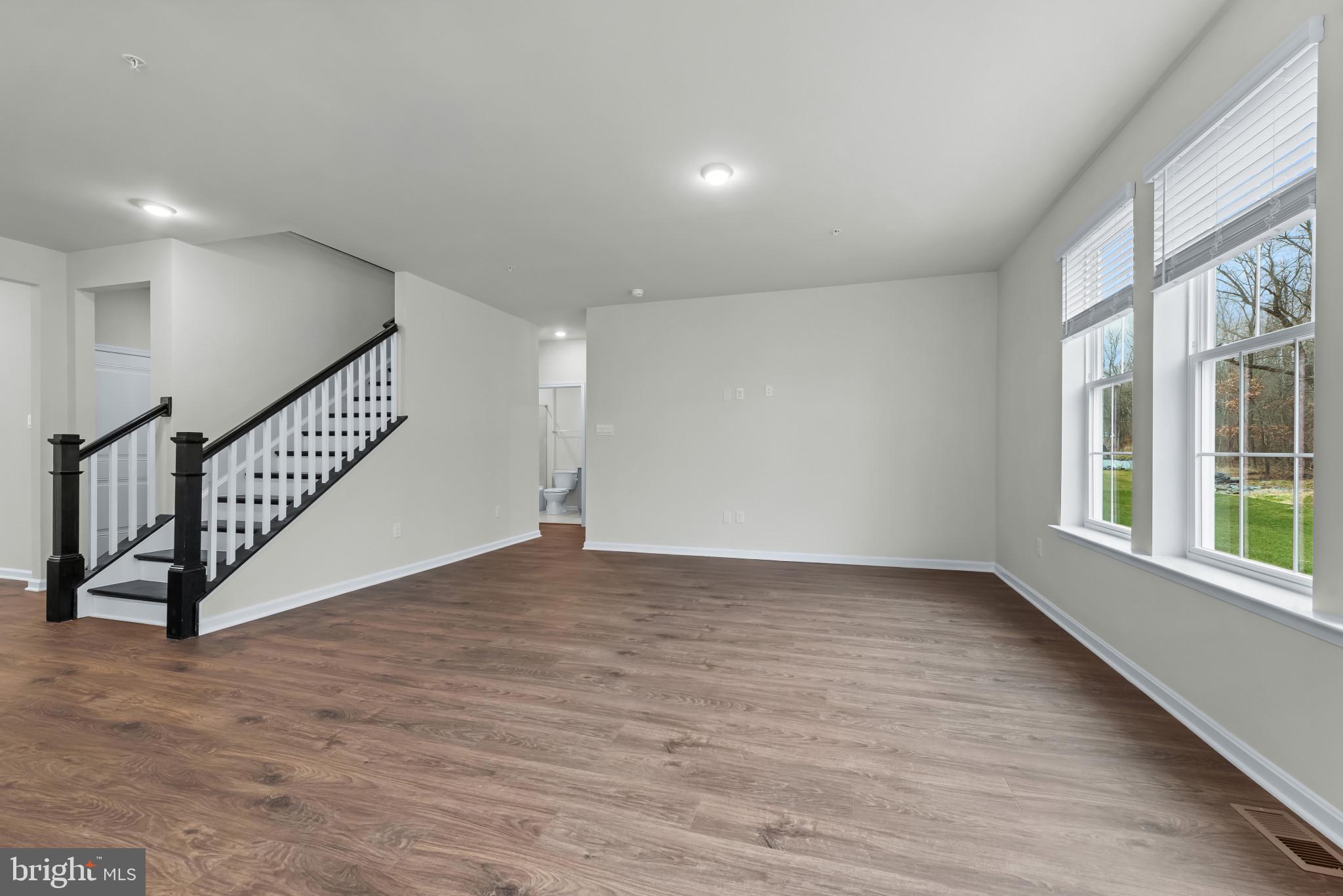 1204 Otter Point Middle River, MD 21220 - Photo 4 of 32 an empty room with wooden floor and windows