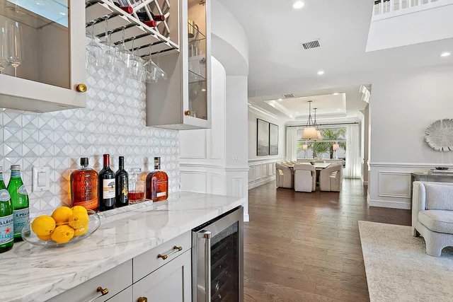 a kitchen with stainless steel appliances granite countertop a sink a counter space and living room view