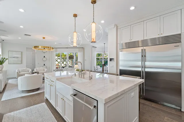 a kitchen with stainless steel appliances granite countertop a sink a stove and refrigerator