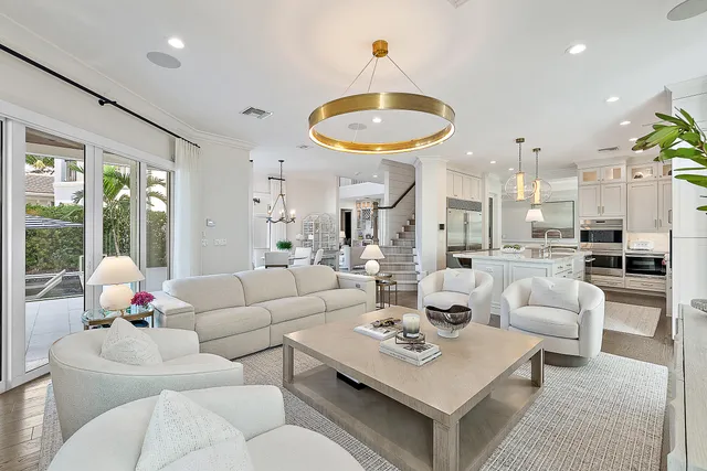 a view of a dining room with furniture a chandelier and wooden floor