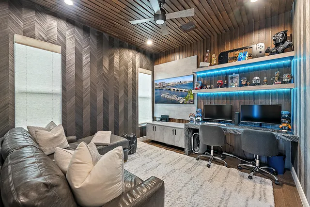 a view of a livingroom with workspace and a large window