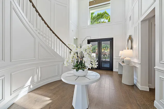 a view of a hallway with wooden floor and windows