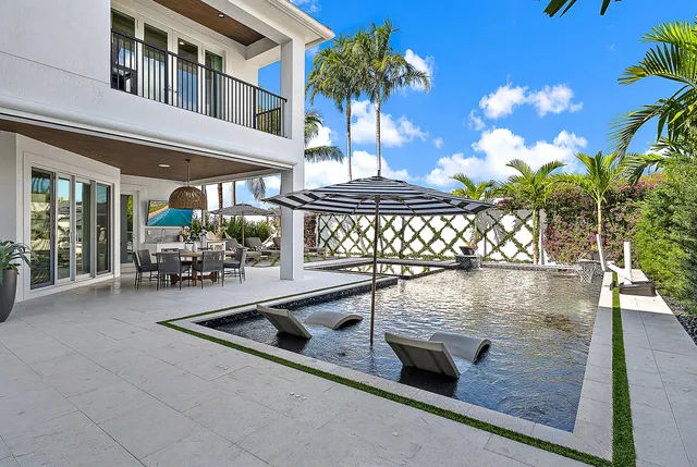 an aerial view of residential house with outdoor space and covered by trees