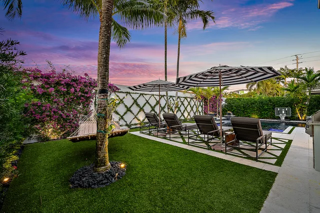 a view of a chair and table in the garden