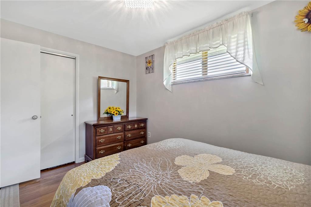 765 Catherine Street Rochester, PA 15074 - Photo 16 of 30 a bedroom with a bed and wooden floor