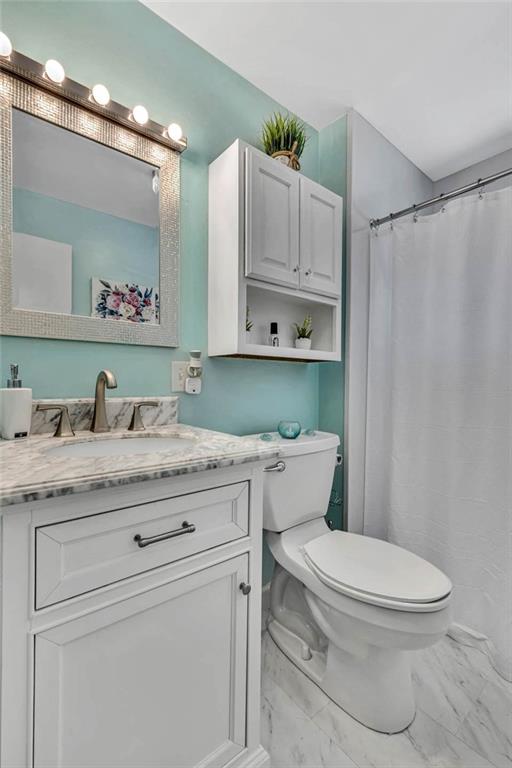 765 Catherine Street Rochester, PA 15074 - Photo 18 of 30 a bathroom with a granite countertop toilet sink and mirror
